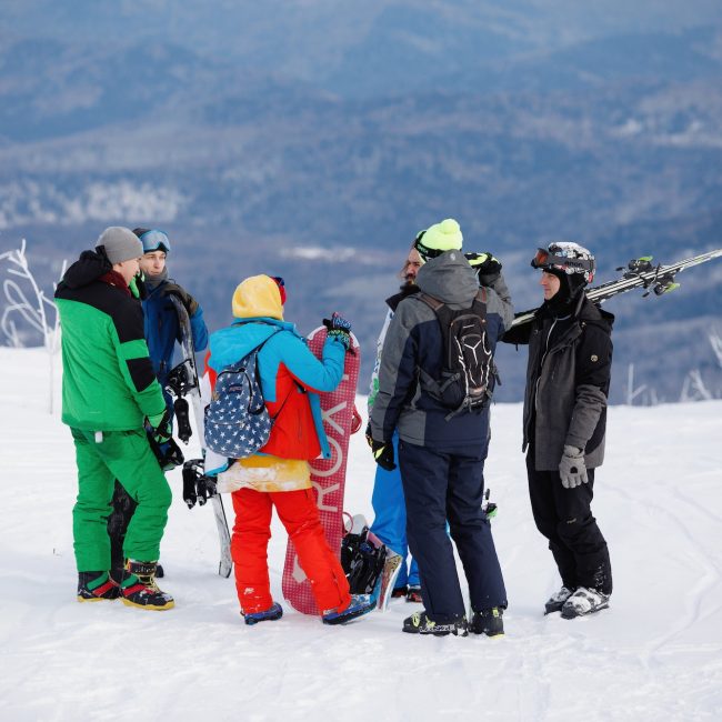 Group of skateboarders at a snow ski resort.